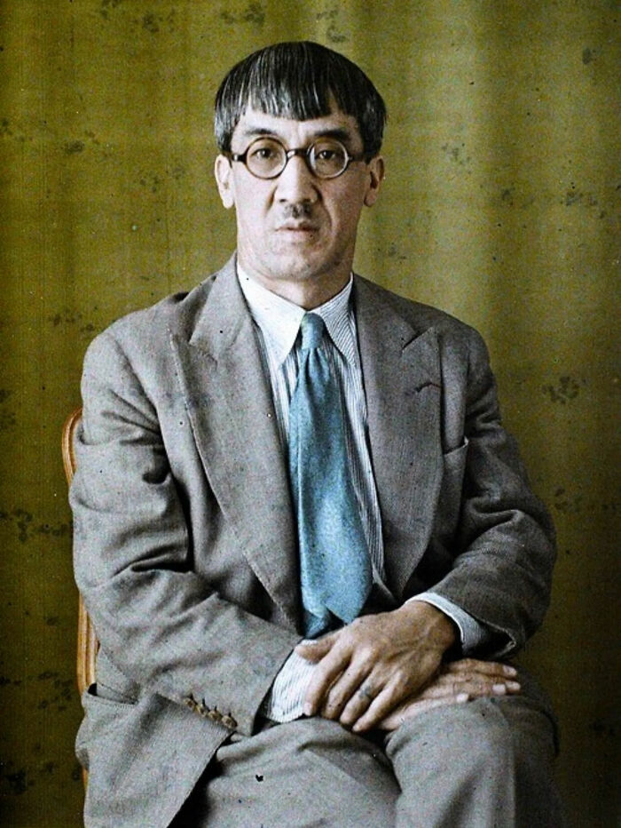 Vintage cat photo showing a cat with scissors held in front of its eyes, creating a playful and quirky feline moment.