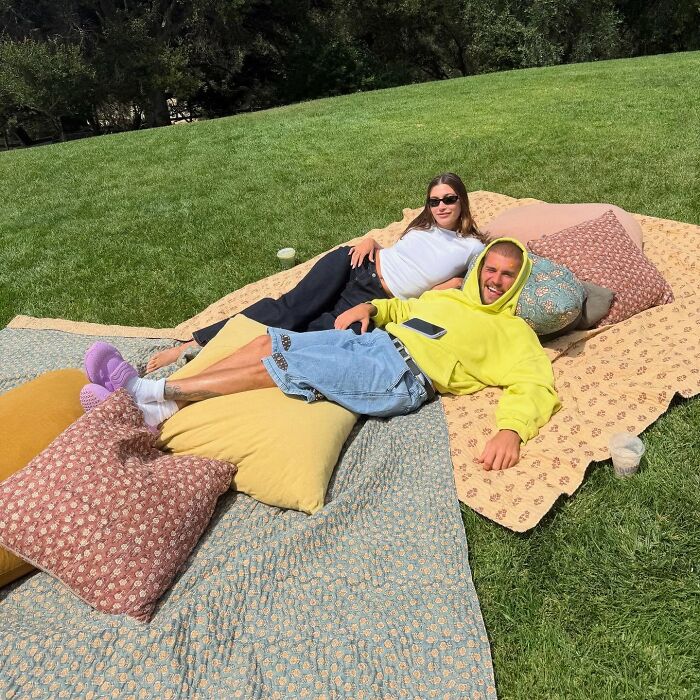 Justin and Hailey Bieber relaxing on blankets outdoors, highlighting the hidden factor behind their troubled marriage. Justin and Hailey Bieber relaxing on blankets outdoors, highlighting the hidden factor behind their troubled marriage.
