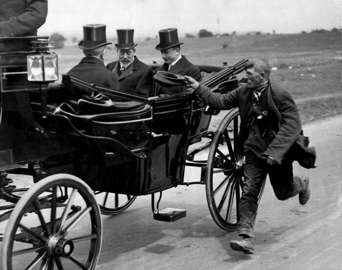 Black and white historical photo of men in top hats riding a horse-drawn carriage, with a man running alongside.