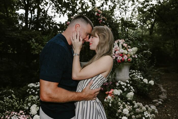Taylor Swift and fianc&eacute; embrace tenderly in a garden surrounded by flowers in heart-melting engagement photos.