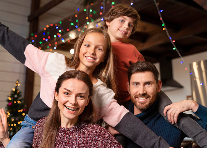 Happy family enjoying festive lights indoors, capturing moments rich people realize their normal life differs widely. - 14