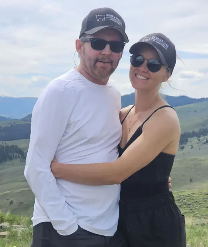 Brandon Blackstock with woman wearing sunglasses and hats outdoors, linked to Kelly Clarkson's ex-assistant news.