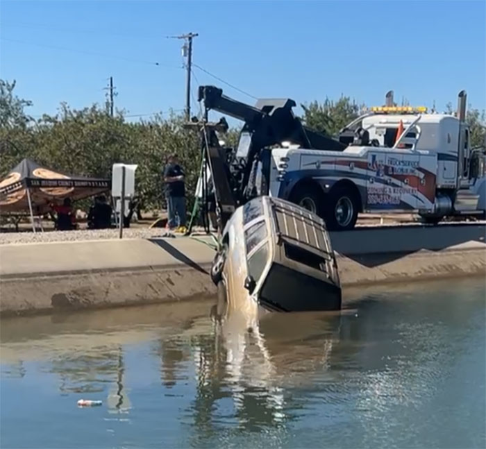 SUV being pulled from canal by tow truck at recovery scene after bodies of missing mom and baby found in water. SUV being pulled from canal by tow truck at recovery scene after bodies of missing mom and baby found in water.
