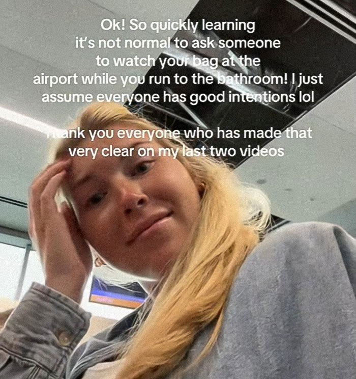 Young woman at airport reacting in a heated debate after passenger slams her for refusing to watch her bag Young woman at airport reacting in a heated debate after passenger slams her for refusing to watch her bag