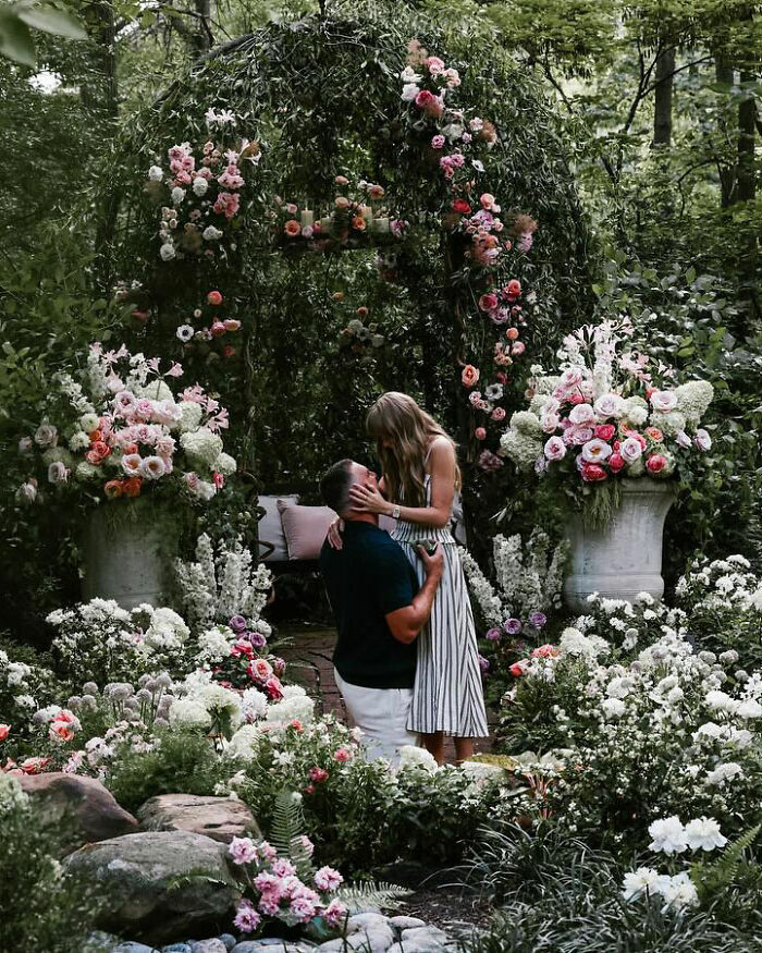 Couple in floral garden, highlighting Taylor Swift furious over Bonnie Blue's comment about Travis Kelce before engagement announcement.