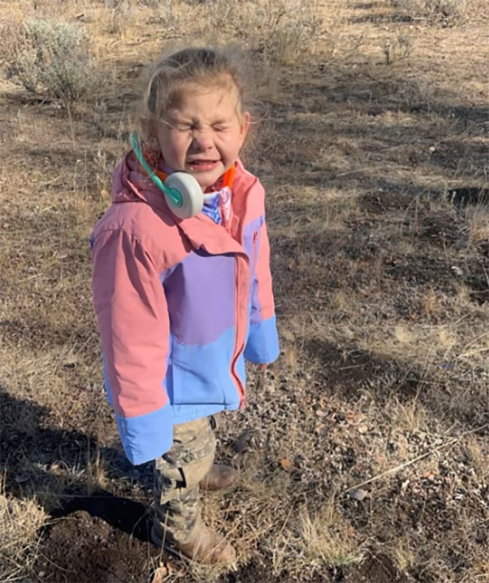 Young child wearing a colorful jacket outdoors, related to family awarded after healthy pregnancy ended with gravely disabled baby.