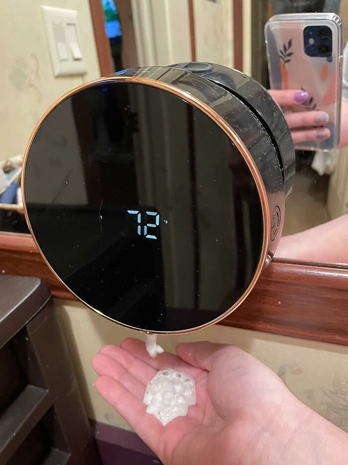 Modern touchless soap dispenser with temperature display in bathroom for low-lift, high-impact improvements.