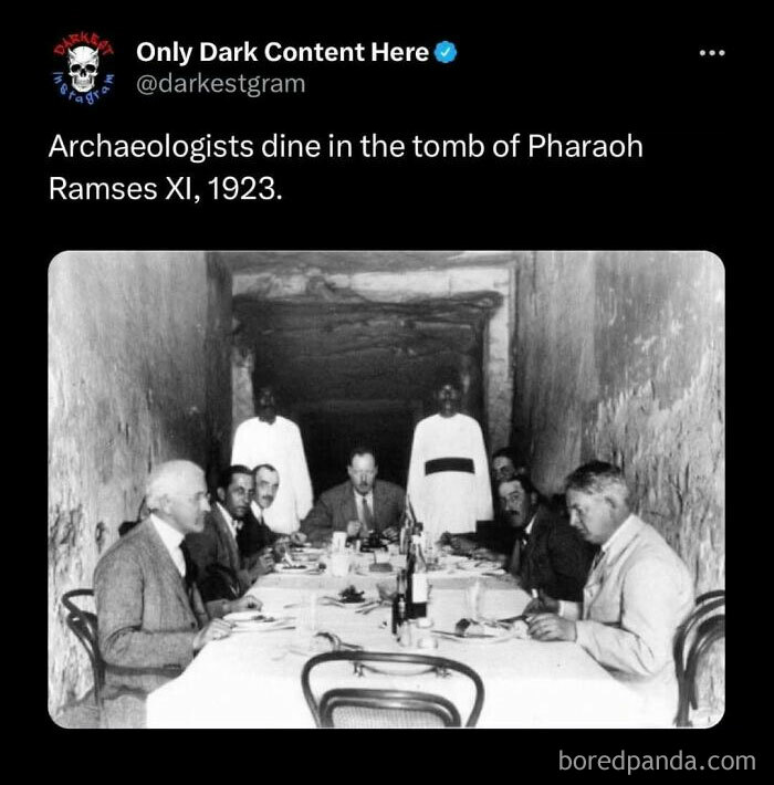 Black and white photo of archaeologists dining in Pharaoh’s tomb, featured on a darkest page on Instagram with dark content.