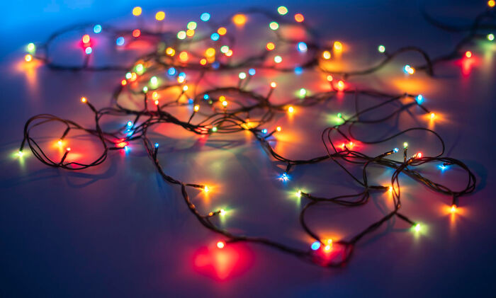 Colorful string lights tangled on a surface, illustrating creative and wild things school kids pulled off with confidence.