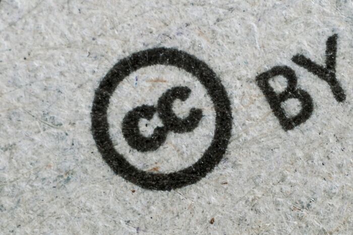 Close-up of a creative ingenious invention symbol printed on textured paper, illustrating repurposed designs over years.