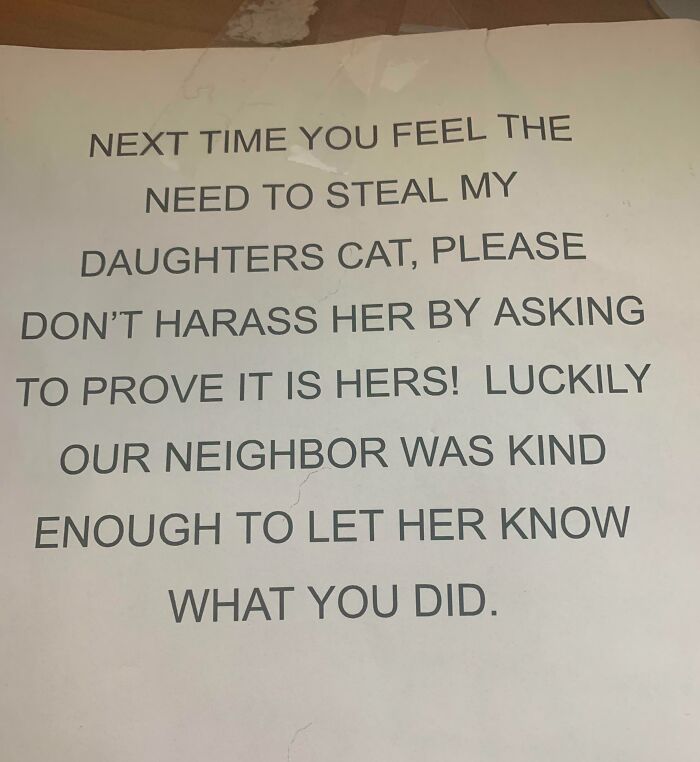 Note from unhinged neighbor warning against stealing a cat and harassing the daughter, highlighting difficult neighbor interactions.