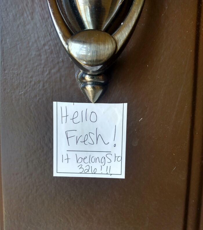 Handwritten neighbor's note on a front door addressing a delivery, illustrating unhinged neighbors’ notes humor in daily life.