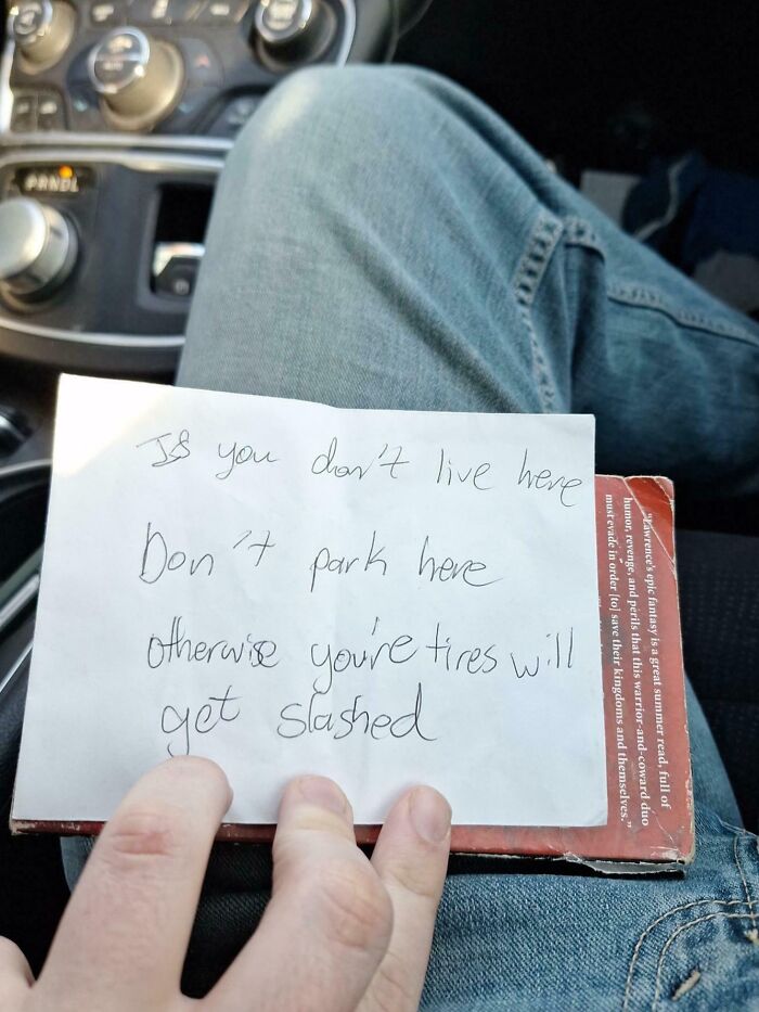 Handwritten unhinged neighbor’s note warning about slashing tires for unauthorized parking, showing unusual neighborhood tensions.