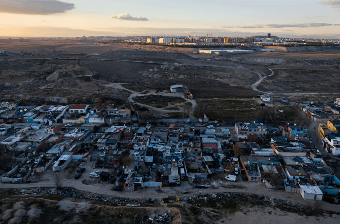Aerial view of urban hell area showing crowded, neglected housing and barren land highlighting societal decay and urban neglect.