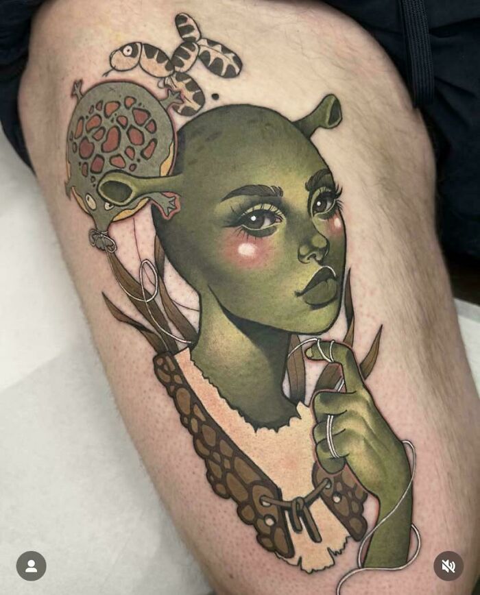 Tattoo of a green alien-like woman with detailed shading and elements, an example of awful taste but great e*******n.