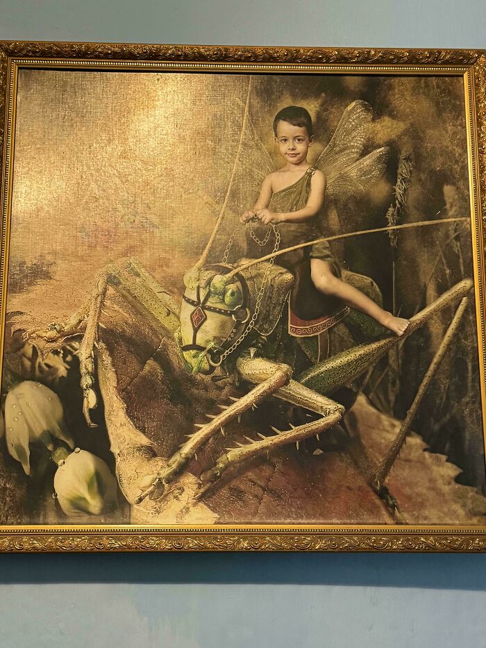 Painting of a child with fairy wings riding a giant grasshopper, an example of awful taste but great e*******n artwork.