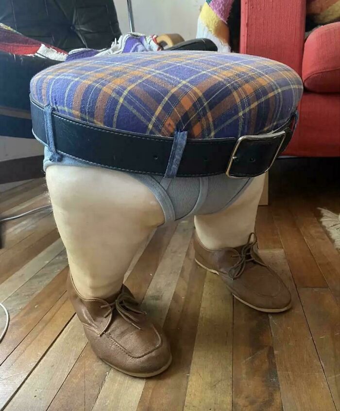 Stool designed with legs wearing underwear, shoes, and a belt, showcasing awful taste but great e*******n in furniture design.