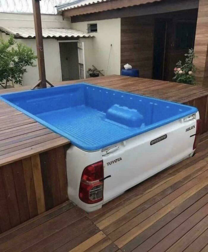 Backyard hot tub made from a Toyota truck bed, showcasing awful taste but great e*******n in design.