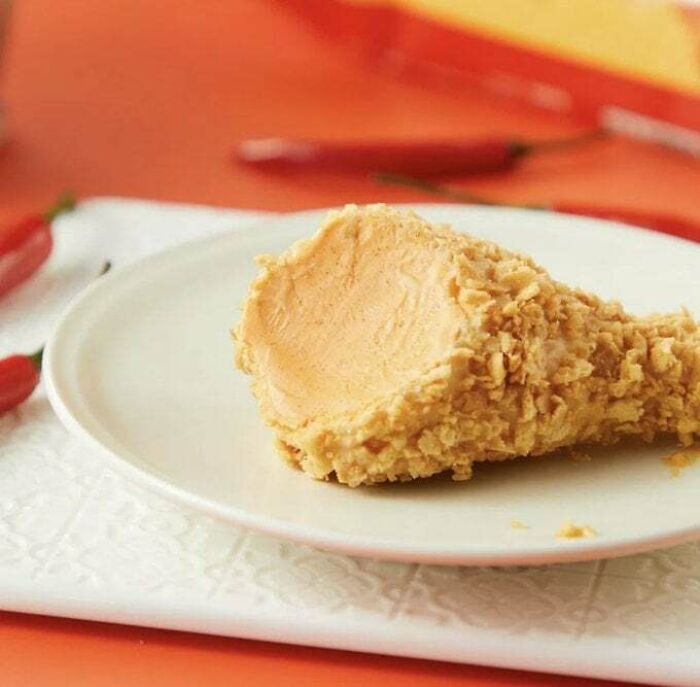 Fried chicken drumstick shaped peanut butter scoop on a white plate, an example of awful taste but great e*******n.