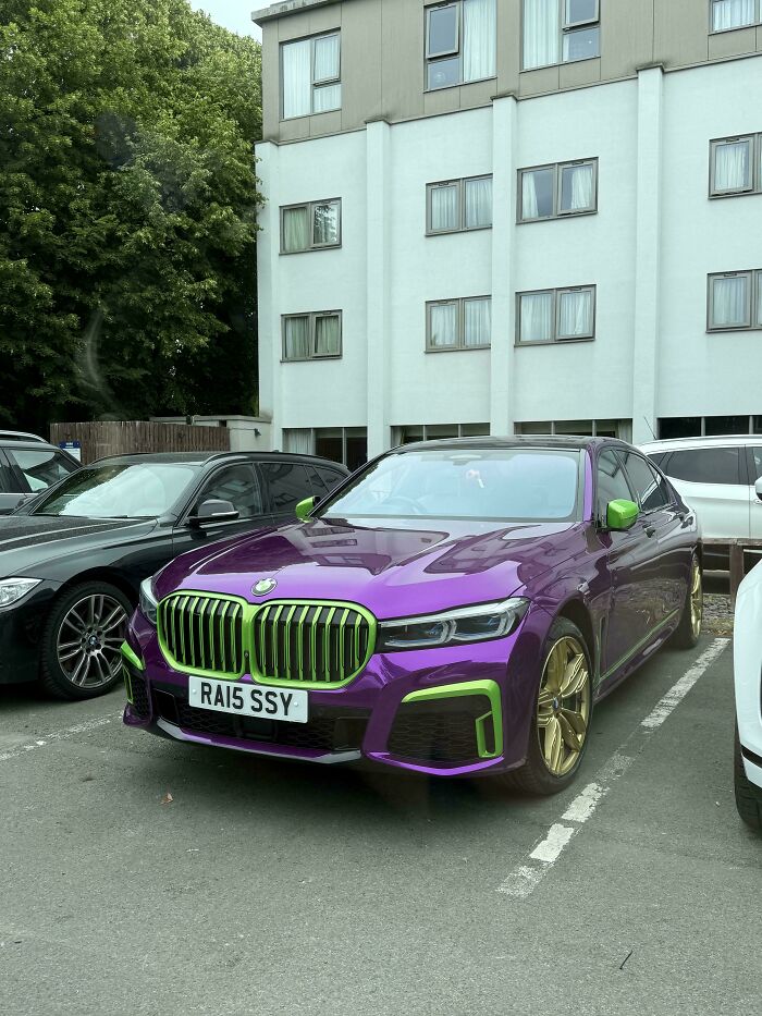 Purple BMW with green accents and gold rims parked in a lot, an example of awful taste but great e*******n.