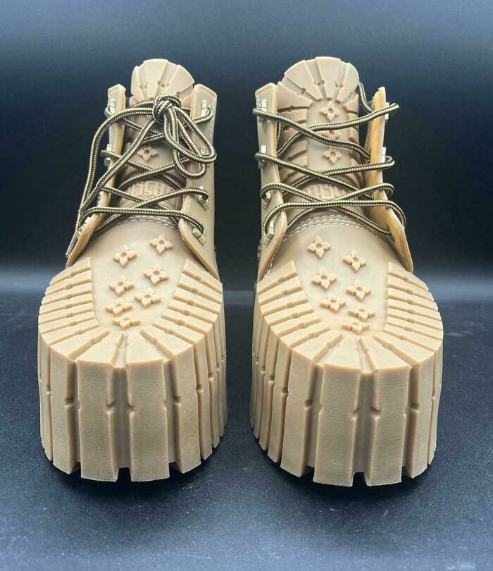 Chunky beige boots with exaggerated thick soles and unconventional design as a funny example of awful taste but great e*******n.