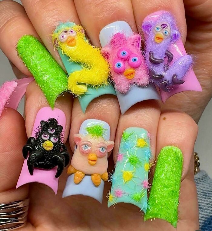 Fuzzy 3D animal face nail art with bright colors, showcasing funny examples of awful taste but great e*******n design.