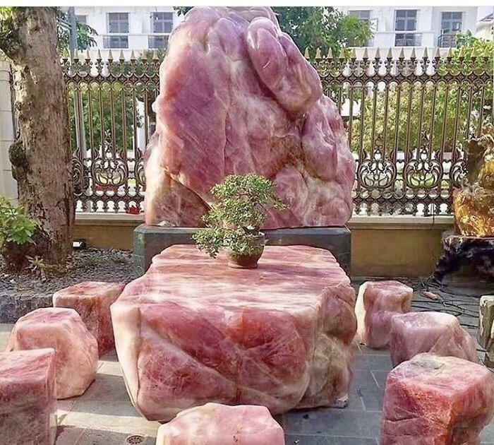 Outdoor seating set made of large pink stone blocks, an example of awful taste but great e*******n in design.