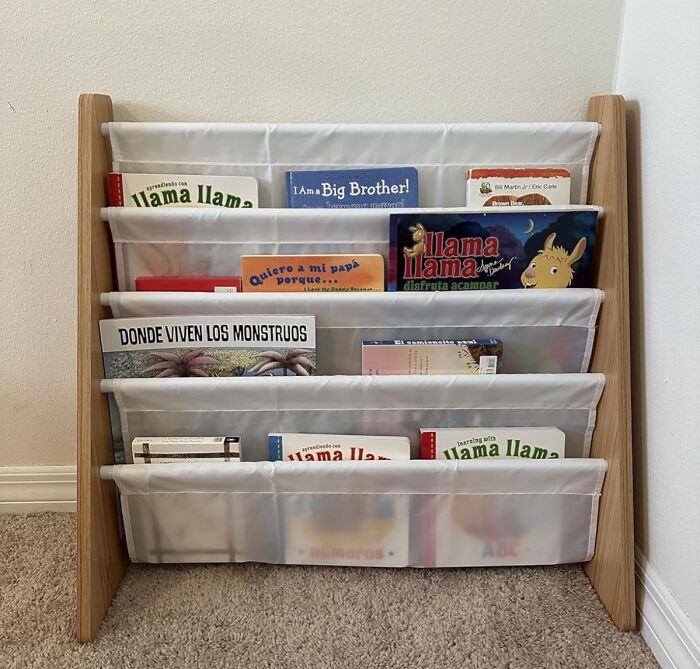 Compact bookshelf with fabric shelves holding children's books, ideal for tiny apartment furniture finds and space-saving solutions.