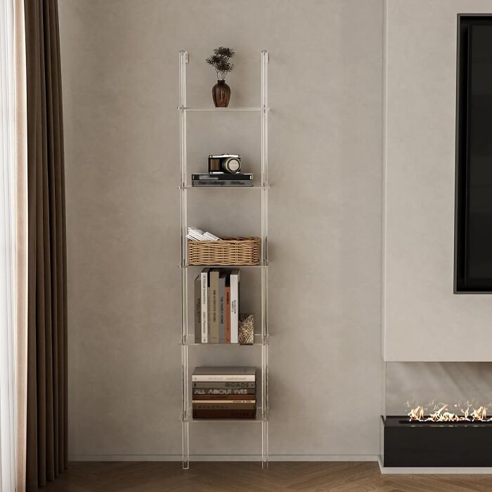 Clear acrylic shelving unit in a modern tiny apartment, showcasing space-saving furniture finds for small living spaces.