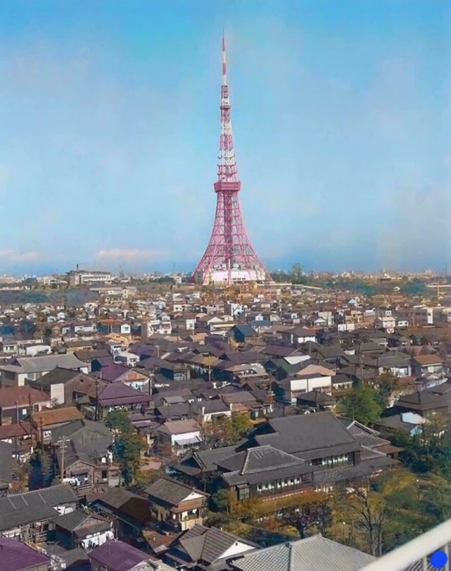 A tall pink tower rising above an urban area, showcasing a unique and interesting community landmark.