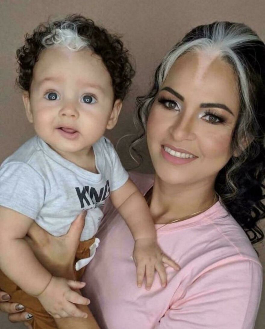Mother and baby with matching hair streaks, showcasing a striking and interesting family moment from an online community post.