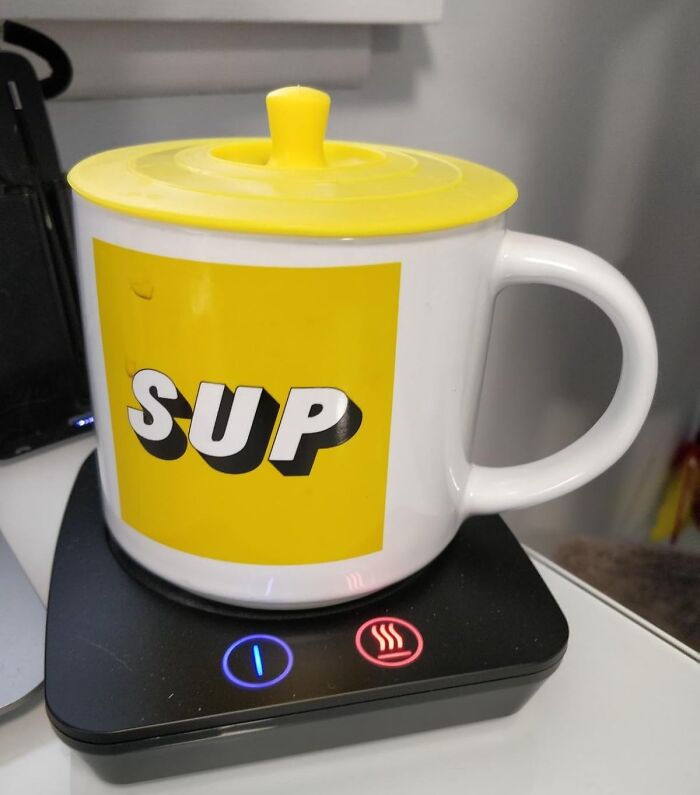 White ceramic mug with yellow lid and SUP text on a warmer, ideal gift for friend barely holding it together