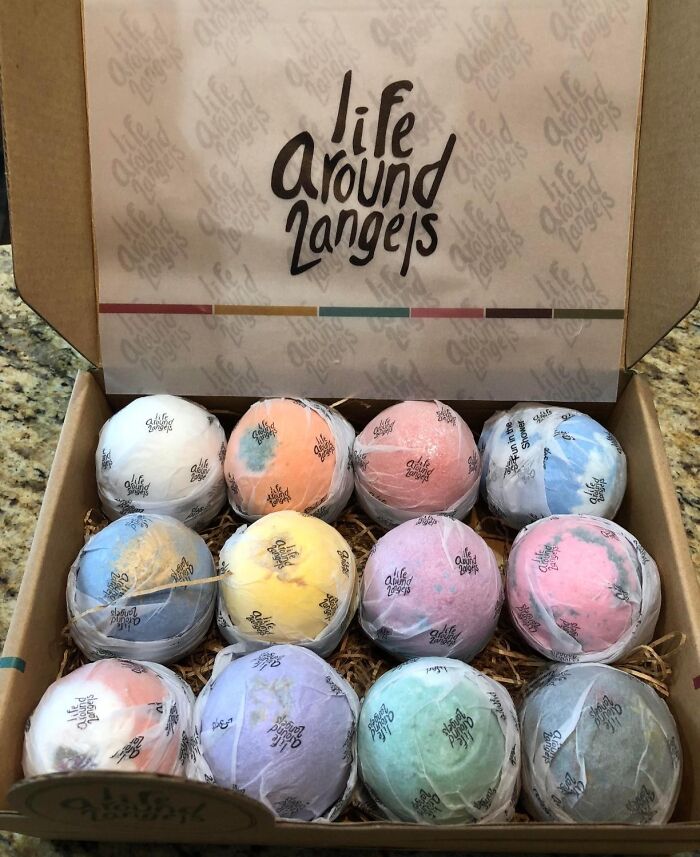 Assorted colorful bath bombs in a gift box from Life Around Langeys for friends barely holding it together