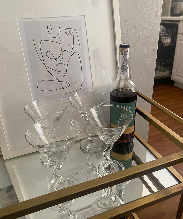 Glass barware set with a bottle on a mirrored tray, ideal gifts for a friend barely holding it together.