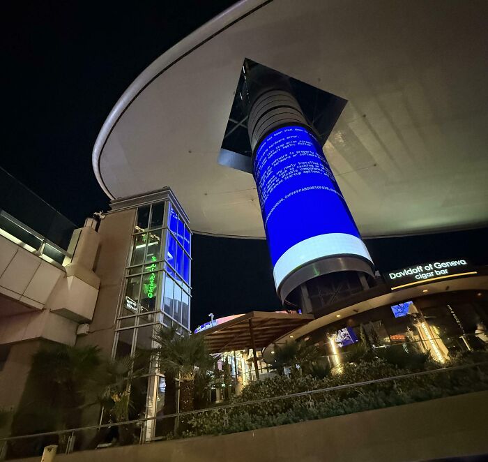 Outdoor digital billboard displaying a blue screen error in a public area, illustrating a funny advertising fail.