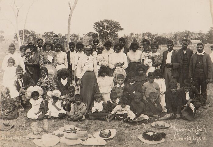Group portrait of Indigenous Australians from the early 1900s showcasing rare glimpses of their community and culture.