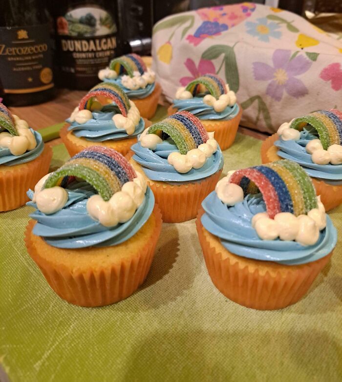 Cupcakes with blue frosting and rainbow candies on top, showcasing incredible bakes that deserve all the spotlight.