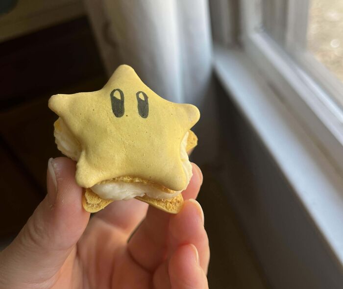 Star-shaped incredible bake with cream filling held near a window showcasing creative and fun baking ideas.