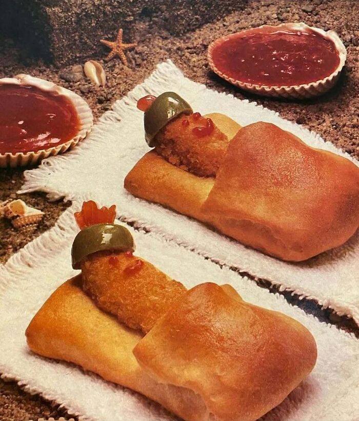 Retro food art featuring vintage-style wrapped snacks resembling sleepy figures with olive hats and ketchup faces.