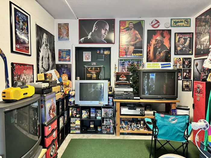 Room filled with 90s memorabilia including vintage TVs and posters