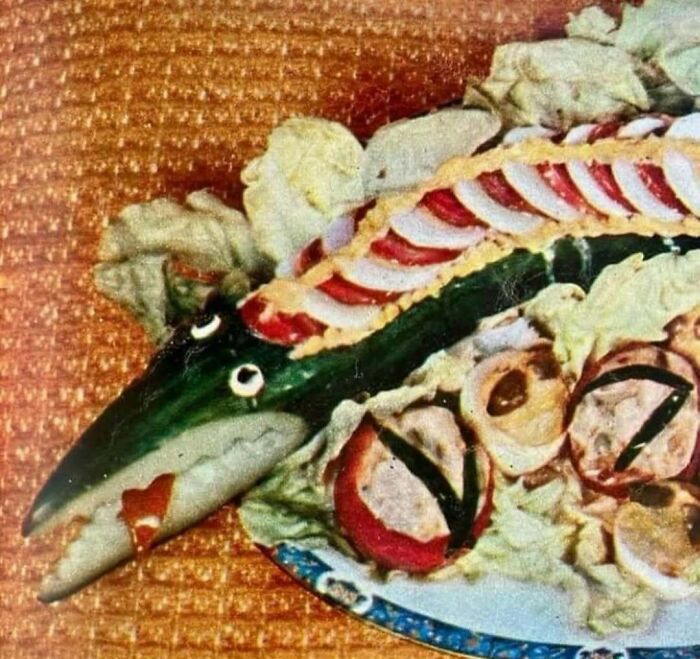 Vintage June Cleavers salad platter with fish-shaped cucumber and decorative sliced vegetables on lettuce bed