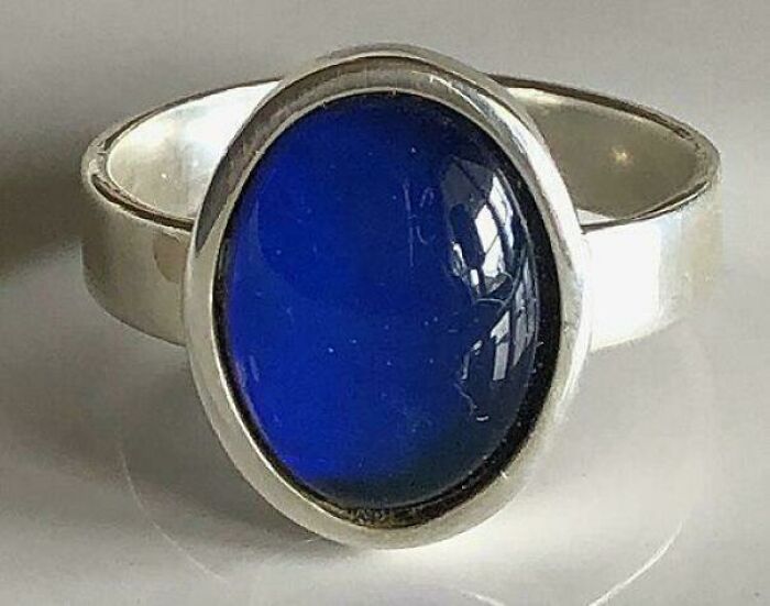 Silver ring with a deep blue oval stone, evoking nostalgic feelings and memories of old age.