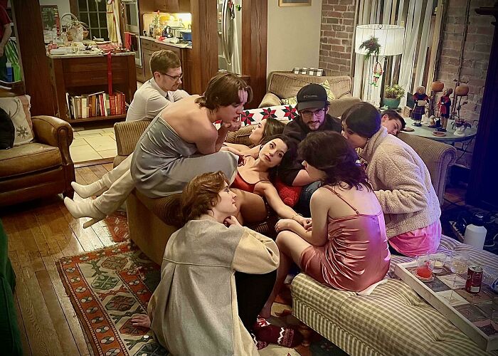 Group of friends in casual home setting creating an accidental renaissance photo with artistic composition and lighting.