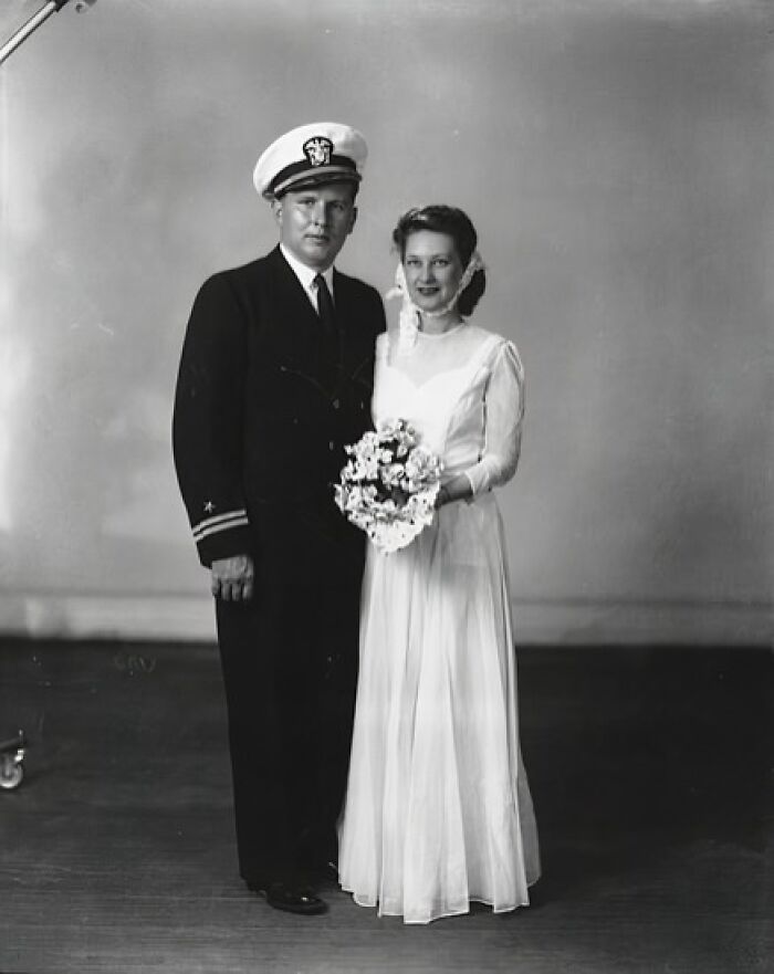 1940s moving wedding photo of a bride in gown and a groom in military uniform showing love in the shadow of war.