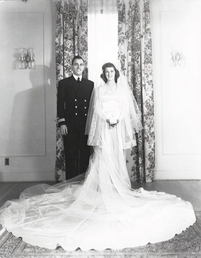1940s wedding photo of bride in long gown and groom in military uniform showcasing love in the shadow of war.