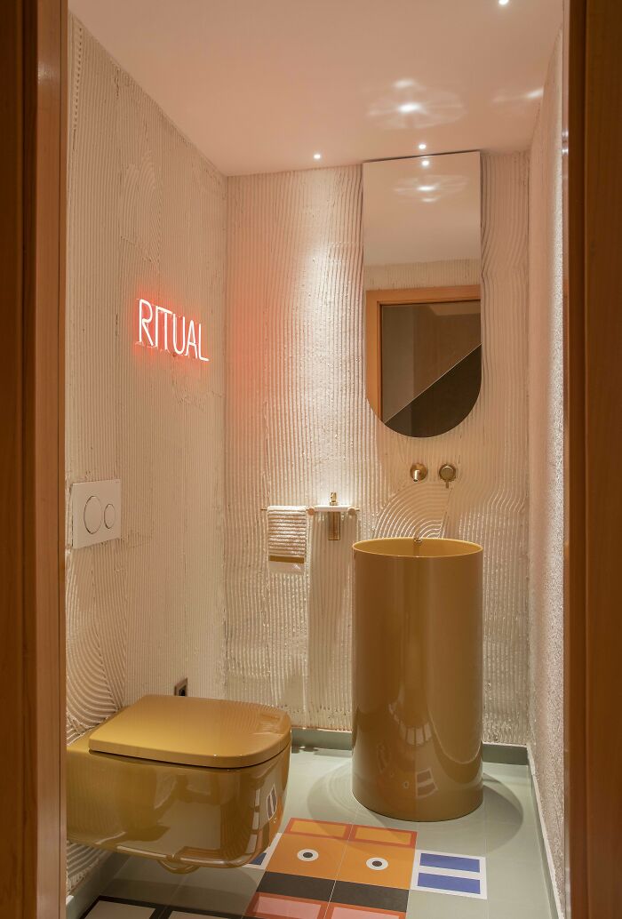 Modern bathroom corner with unique sink and toilet, featuring creative home decorating and stylish design elements.