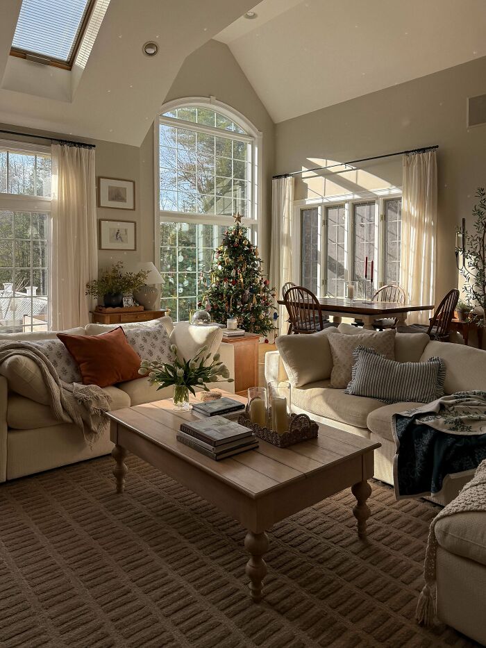 Cozy living room corner decorated with holiday accents, natural light, and comfortable seating showcasing home decorating pride.