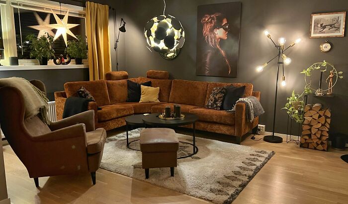 Cozy living room corner with warm lighting, modern decor, and stylish furniture showcasing home decorating pride.