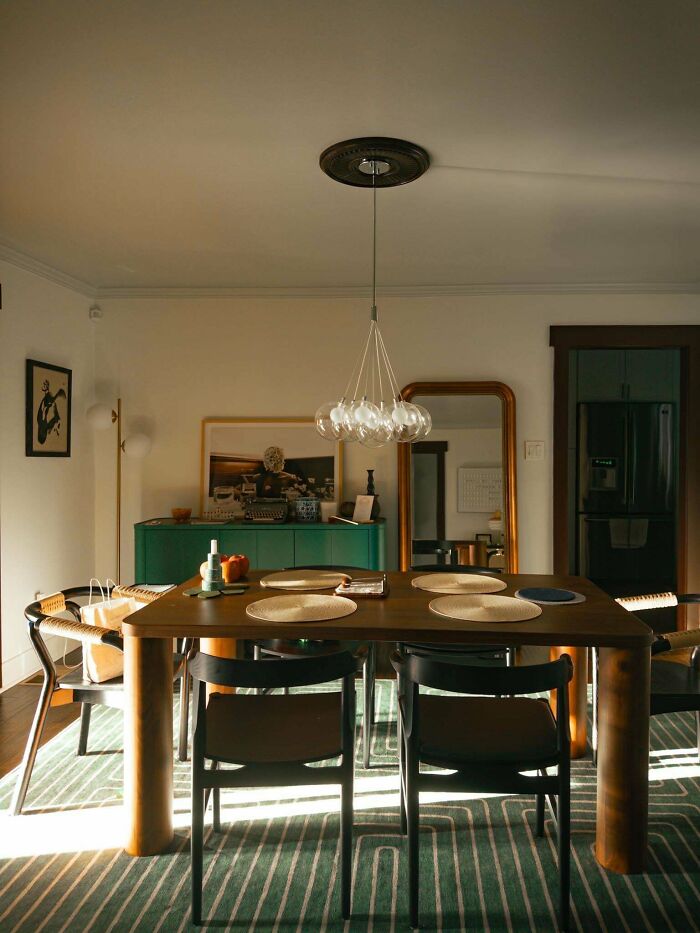 Dining area with wooden table and modern chairs, showcasing a cozy corner of home proud decorating.
