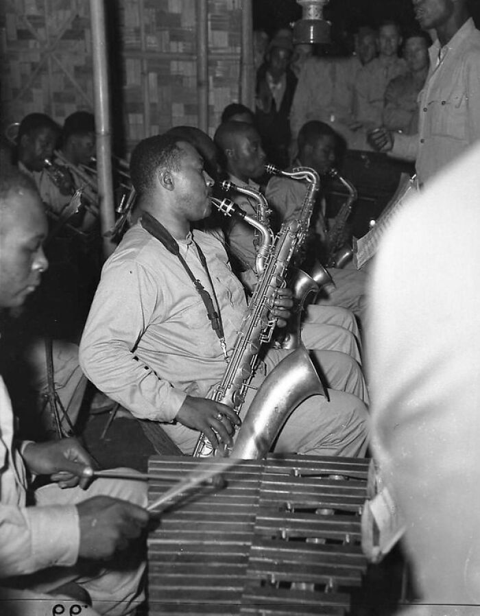 Rare WWII photo of African American soldiers playing saxophones and vibraphone in a military band during a wartime event.
